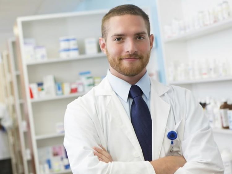 person in lab coat crossing their arms