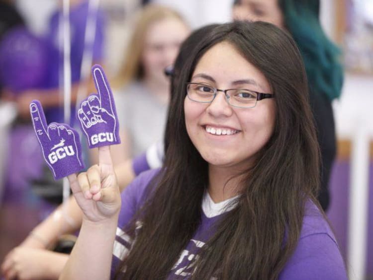 GCU student throwing up a Lope hand sign