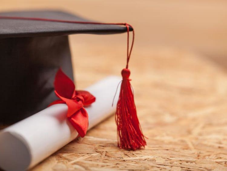 Close-up of grad cap and diploma