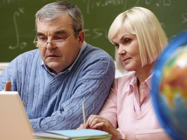 An older couple looks at a laptop