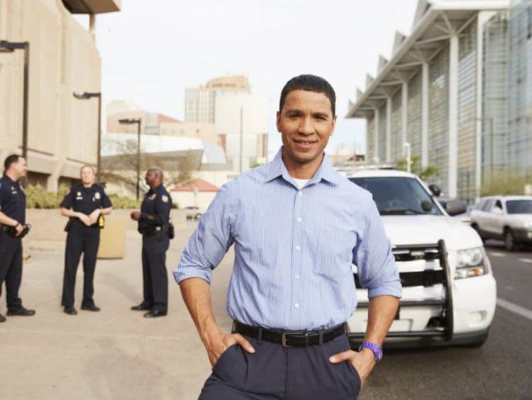 person in front of a cop car