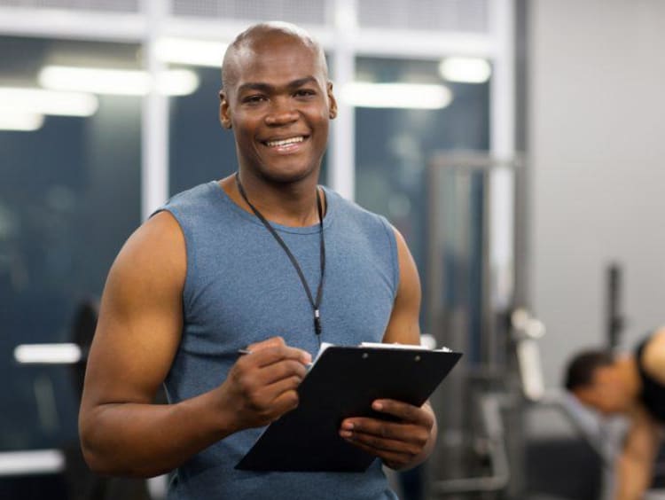 physical trainer holding clipboard