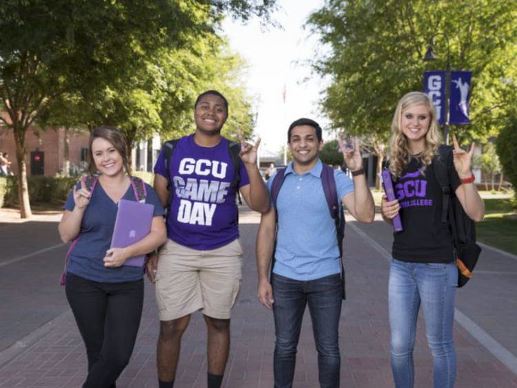 four students holding a lopes up