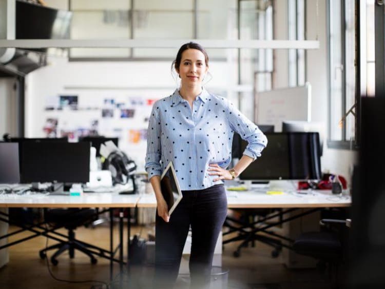 Businesswoman standing with digital tablet