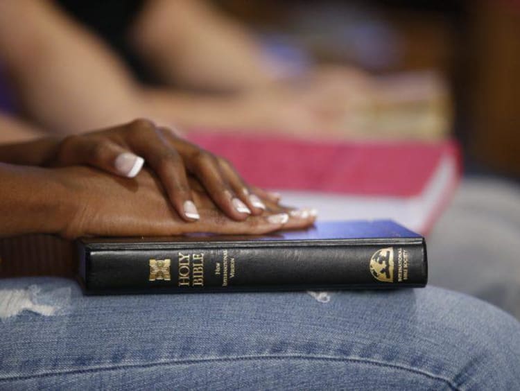 person holding bible on their lap