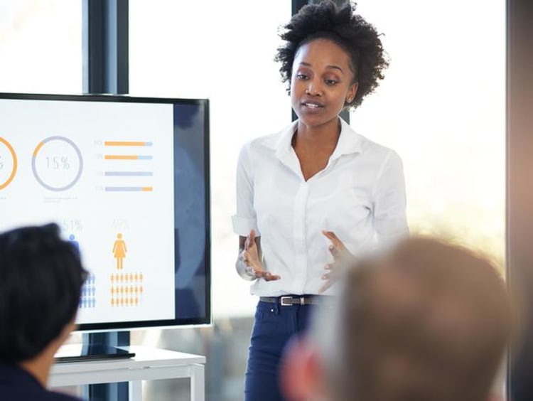 Woman gives marketing presentation during a meeting