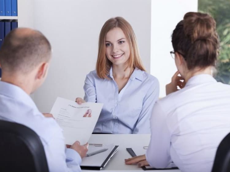 two people interviewing a girl 