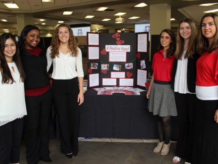 GCU Honors students in front of their symposium project