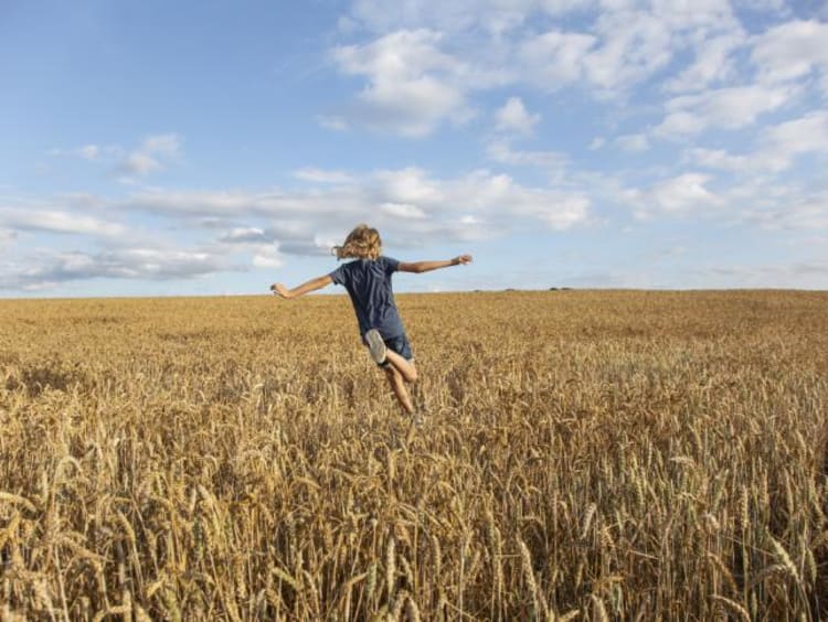 a girl running through a field