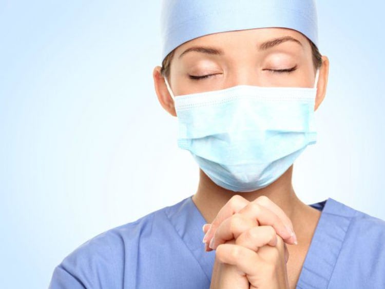 Nursing student prays close up