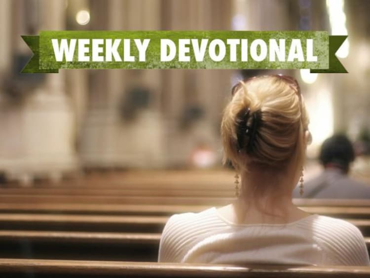 A woman sitting in a pew under the Weekly Devotional banner