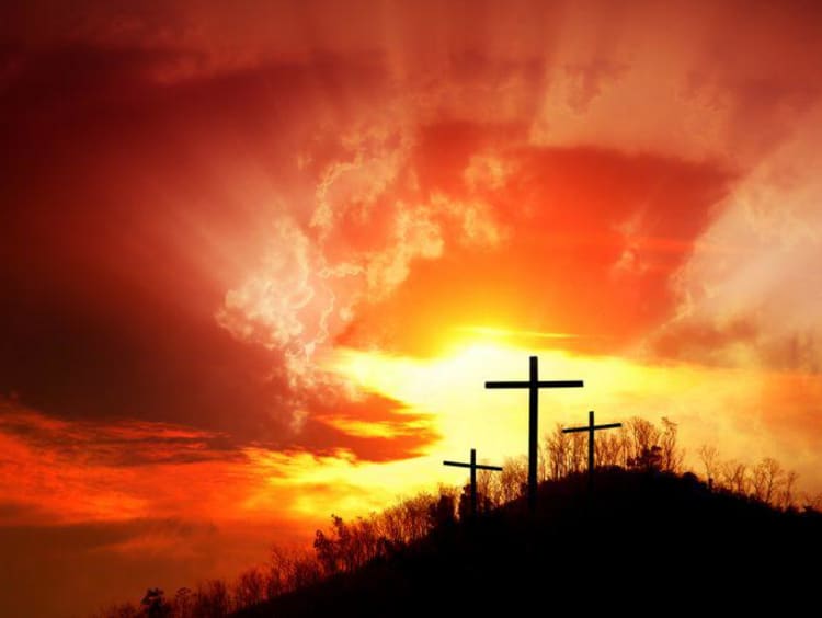 A hilltop with crosses at sunset