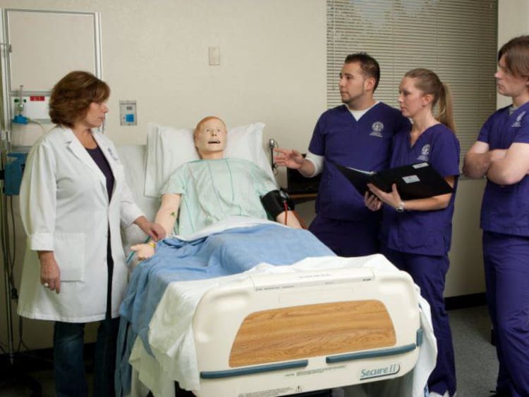 Nursing students learn patient techniques in a clinical setting