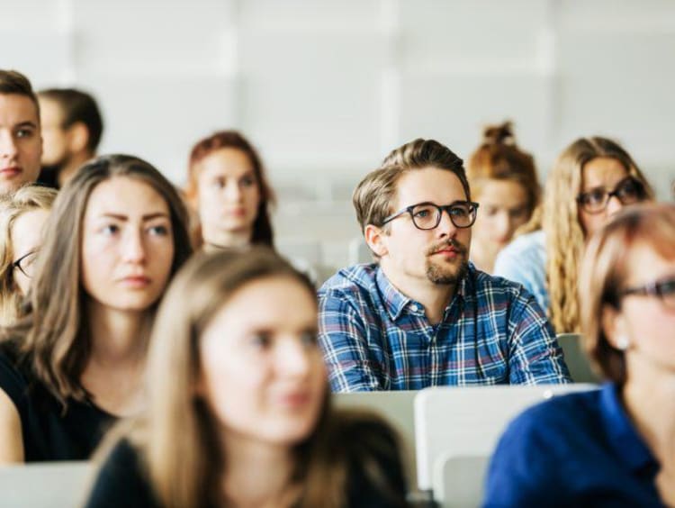 Nursing students attentively listening during class.