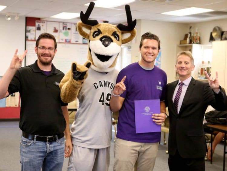 gcu mascot and three people smiling