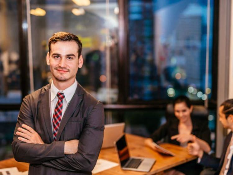 A businessman standing in front of a board room