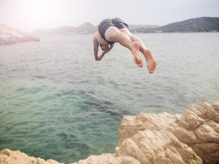 Man diving into a lake