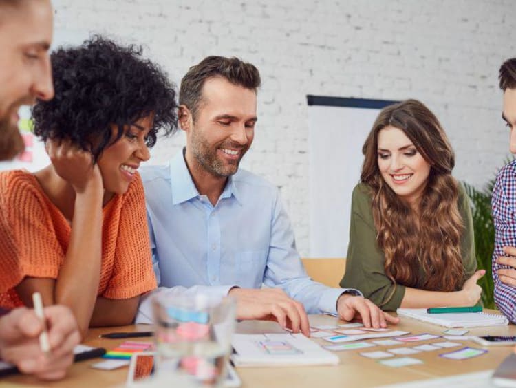 Group of professionals talking and smiling