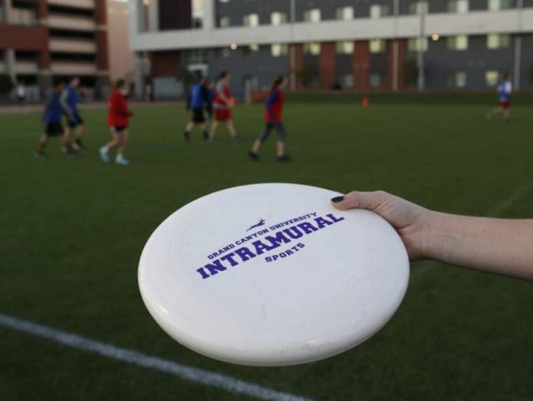 A GCU student playing Frisbee by the Grove dorms