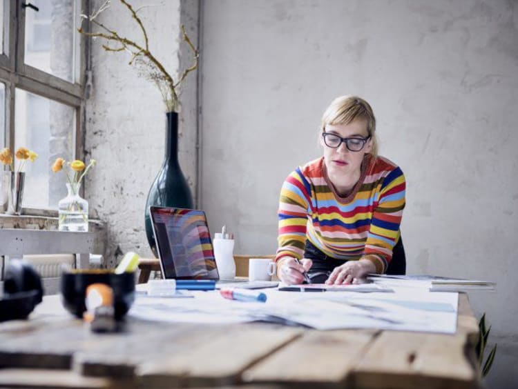 Portrait of woman working at desk in a loft