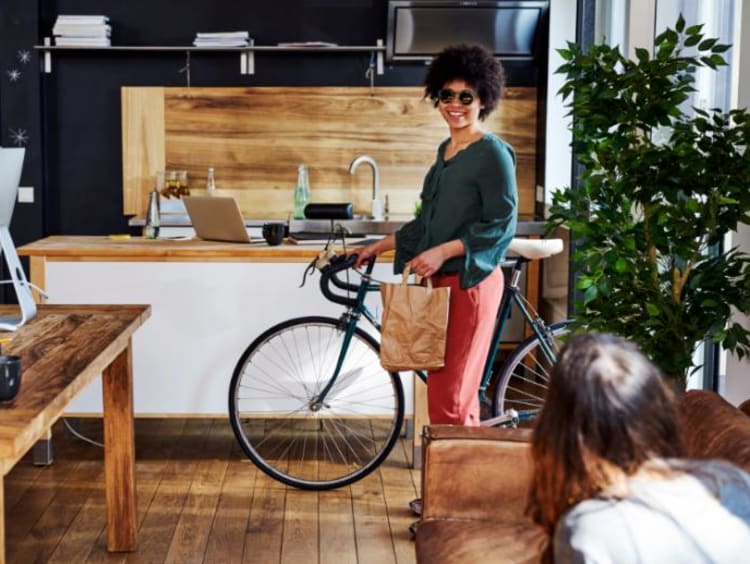 woman riding a bike to support sustainability efforts