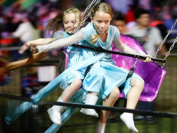 Children on swings at the Fall Fair