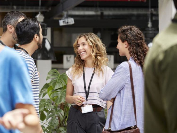 a group of MBA students networking outside of class