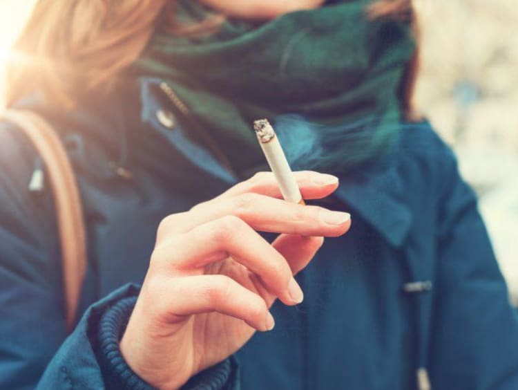 A woman smoking outside