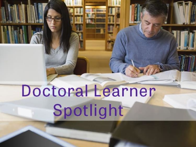 Students study in library setting on laptops