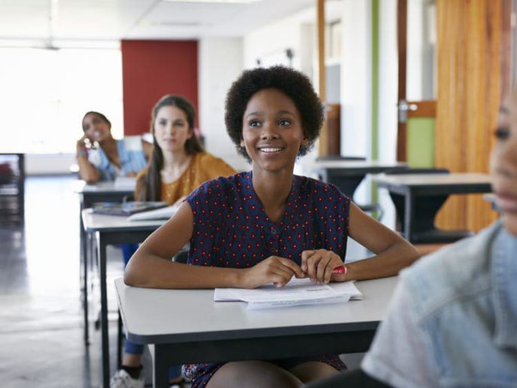 Young woman at desk looking attentively