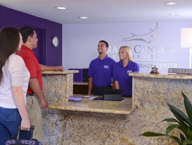 Couple checks in at the GCU Hotel reception desk