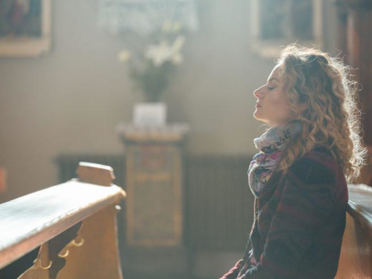 woman praying in a church