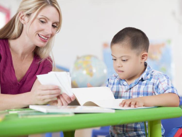 teacher working with a special needs student