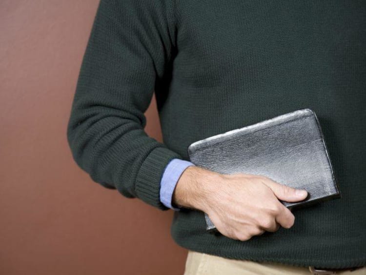 close up of man holding his Bible 