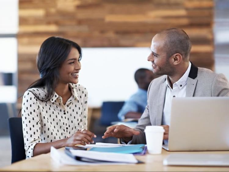 a woman and man working on a project together
