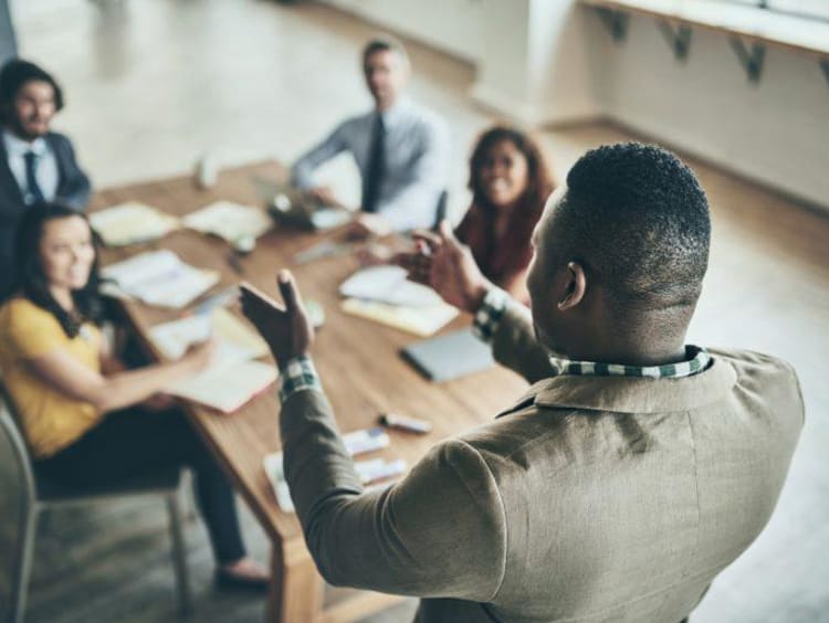 person speaking to a group of people