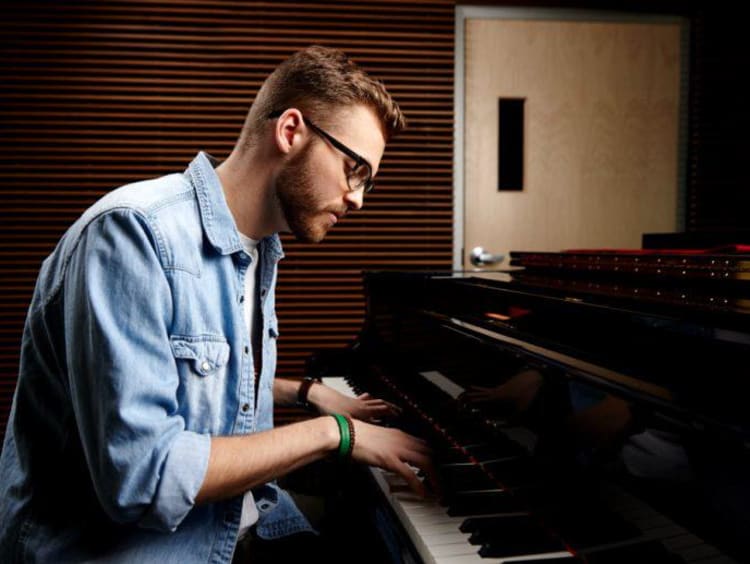 A man playing worship music on the piano