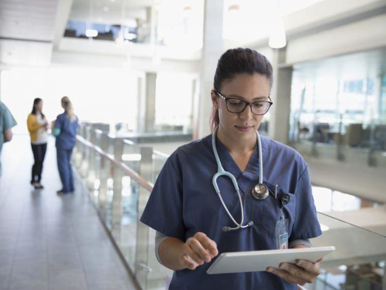 nurse looking at clip board