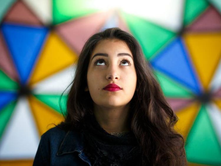 Woman with stained glass behind her