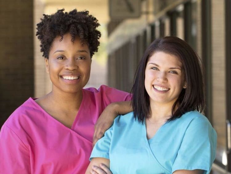 two nurses smiling