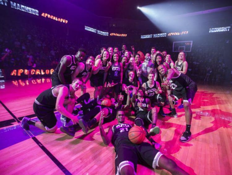 GCU basketball players huddling at a game