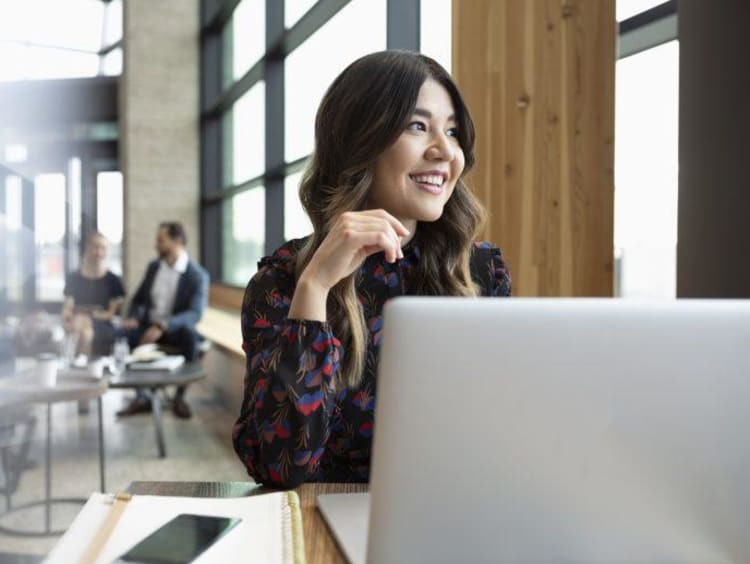 business student in front of their laptop