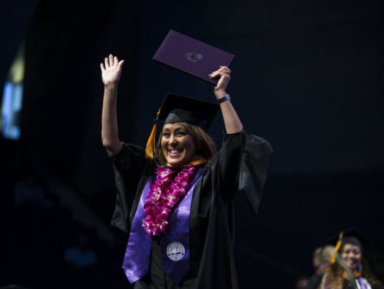 A GCU student celebrating at graduation