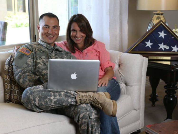 A veteran sitting with his partner in their home
