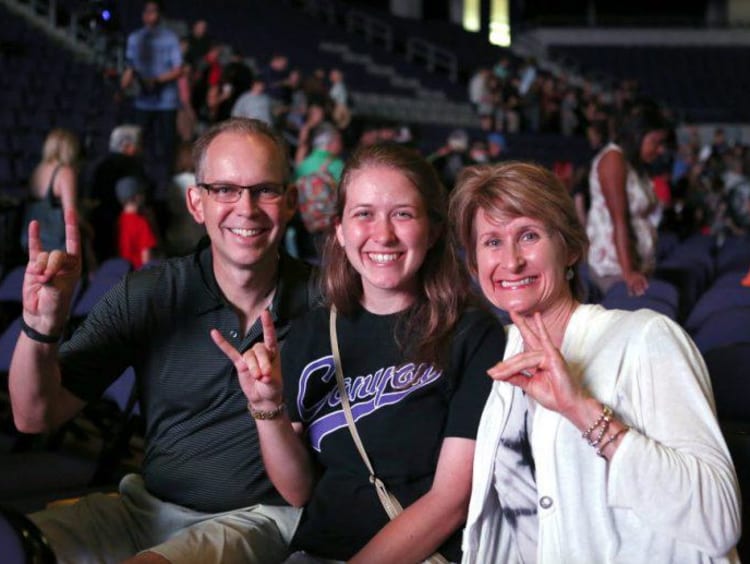 parents and student holding a lopes up