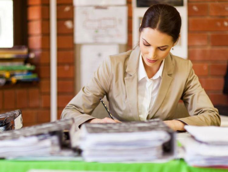 Woman grading stack of papers