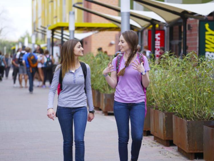 Two GCU girls walking on campus