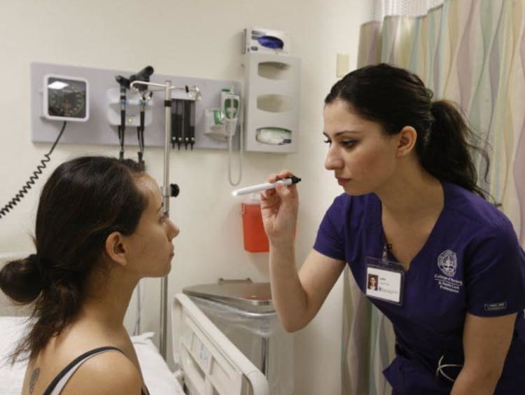 nursing student helping a patient