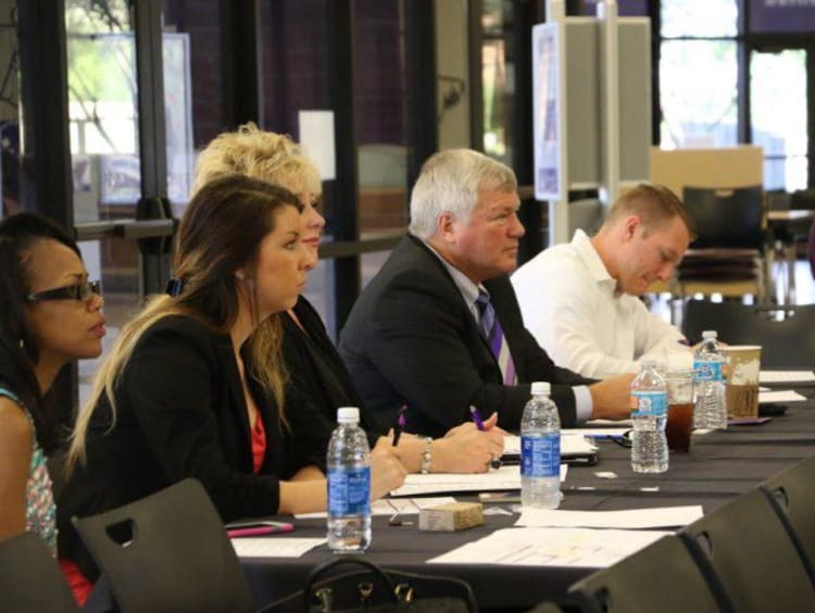 GCU faculty sitting at a long table