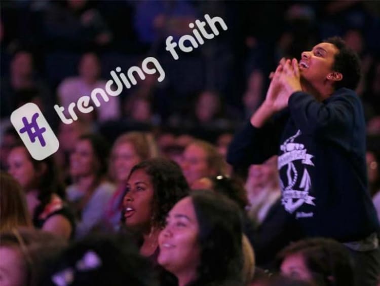 Female student worshiping during Chapel with hashtag trending faith